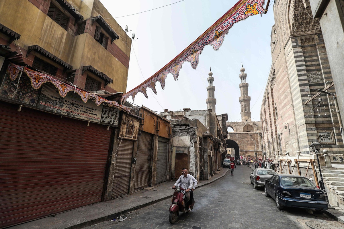 This picture taken on April 24, 2020 on the first Friday of the Muslim holy month of Ramadan shows a view of the area around Bab Zuweila (background), one of the remaining gates in the walls of the old medieval city of Egypt's capital Cairo, almost empty due to the COVID-19 coronavirus pandemic. (Photo by Mohamed el-Shahed / AFP) - AFP
